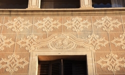 Detall de l’esgrafiat de la façana i dels emmarcaments de les obertures decorades amb un parell d’angelets (2015)
